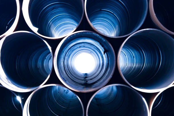 Looking down water well casing pipe with light on the other end